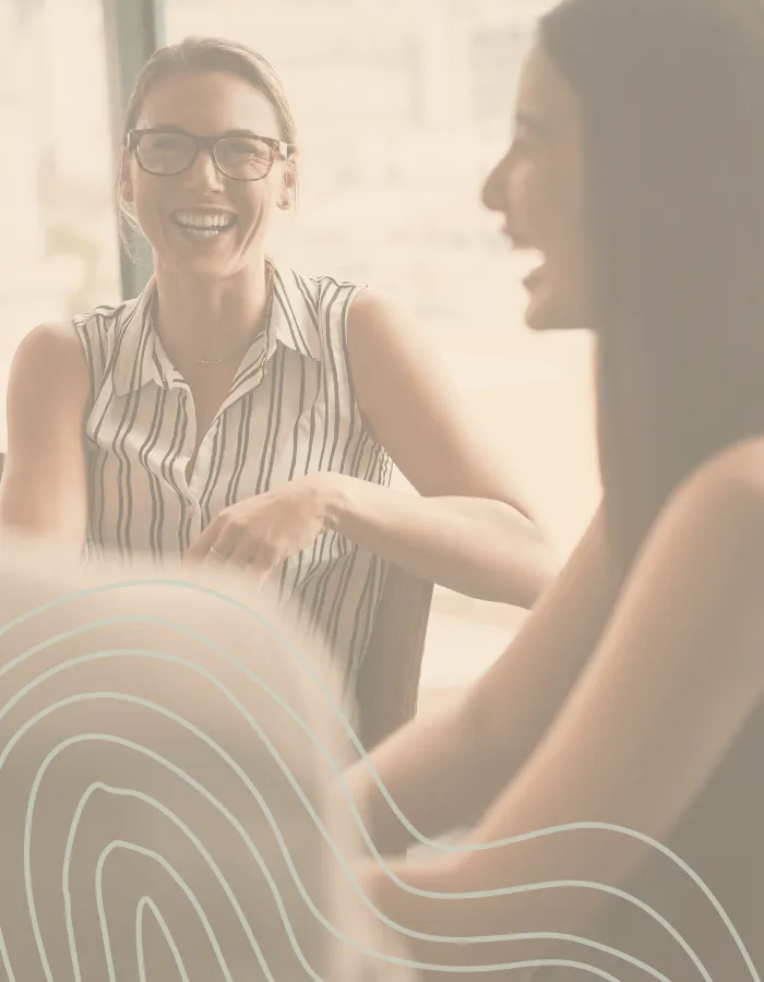 Women having a positive coaching conversation in a relaxed setting