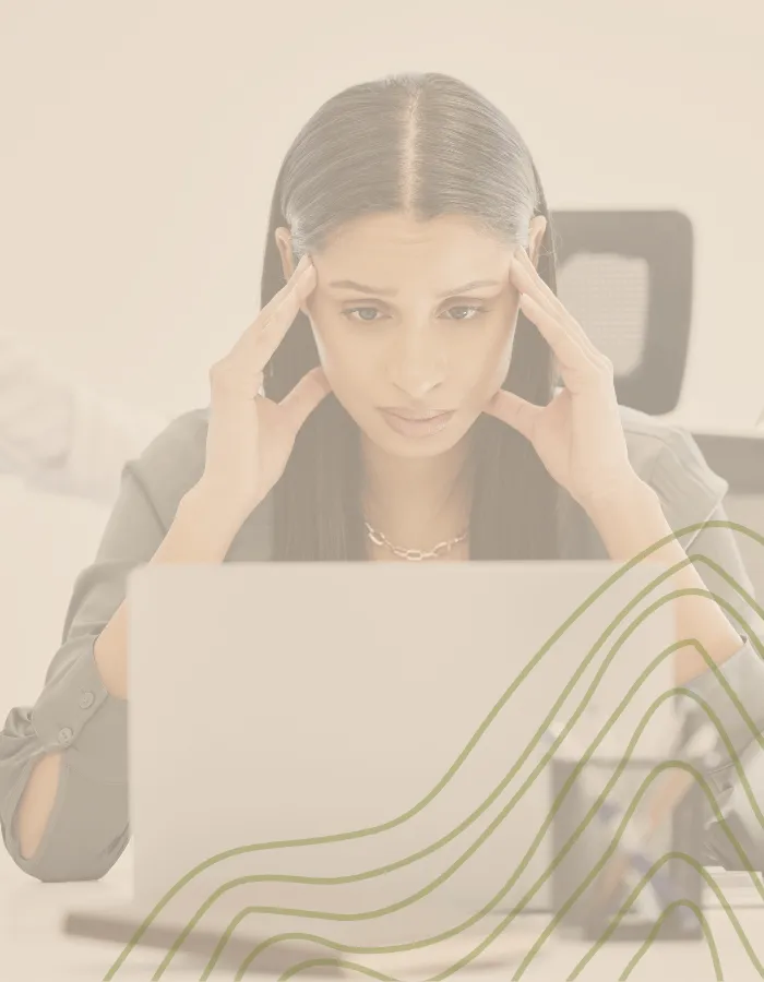 Stressed professional woman overwhelmed at work, symbolizing burnout before coaching