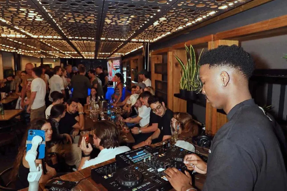 a patio with tables and chairs and an umbrella