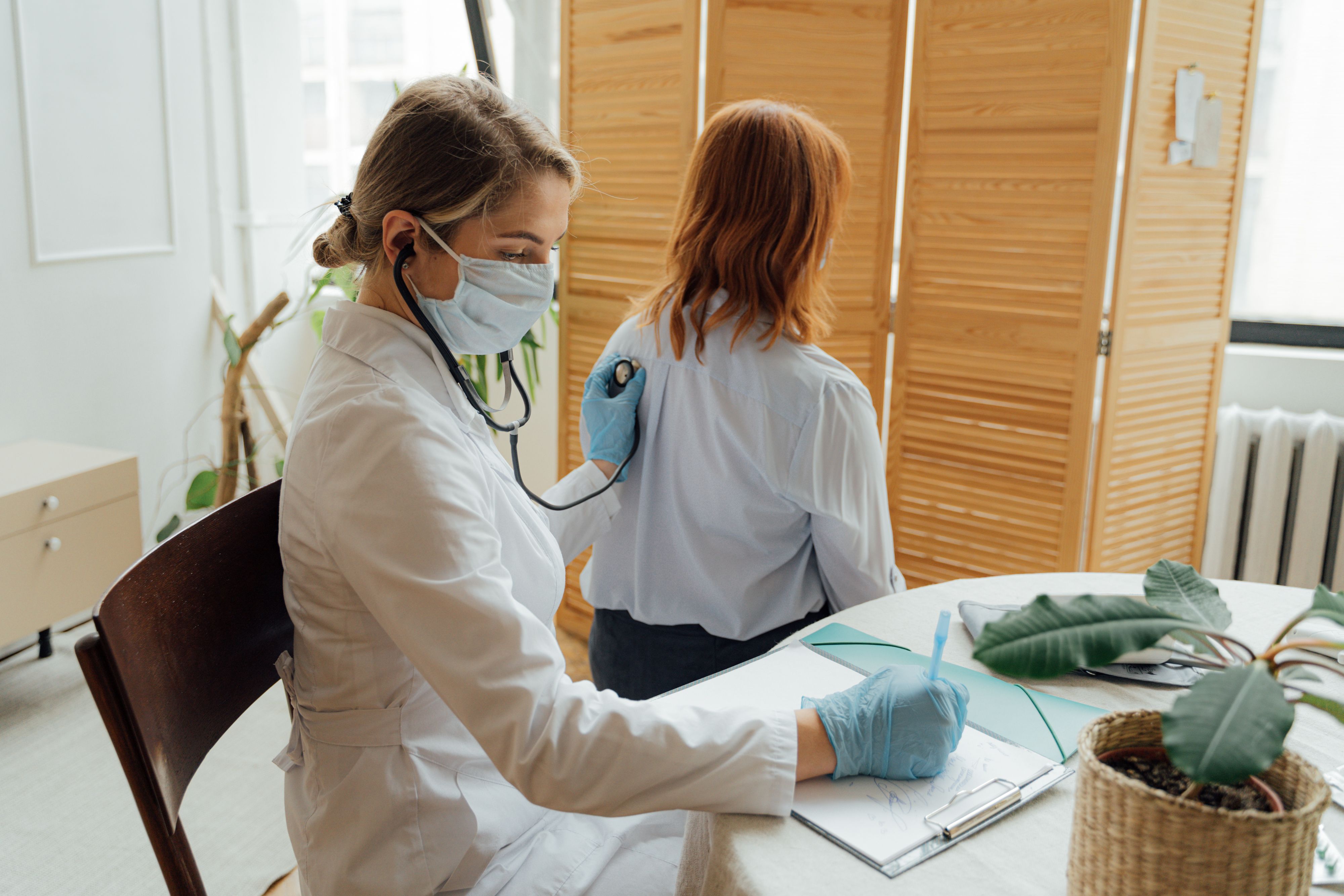 Patient discussing preventive health screenings with a doctor to catch potential issues early and add years to their life