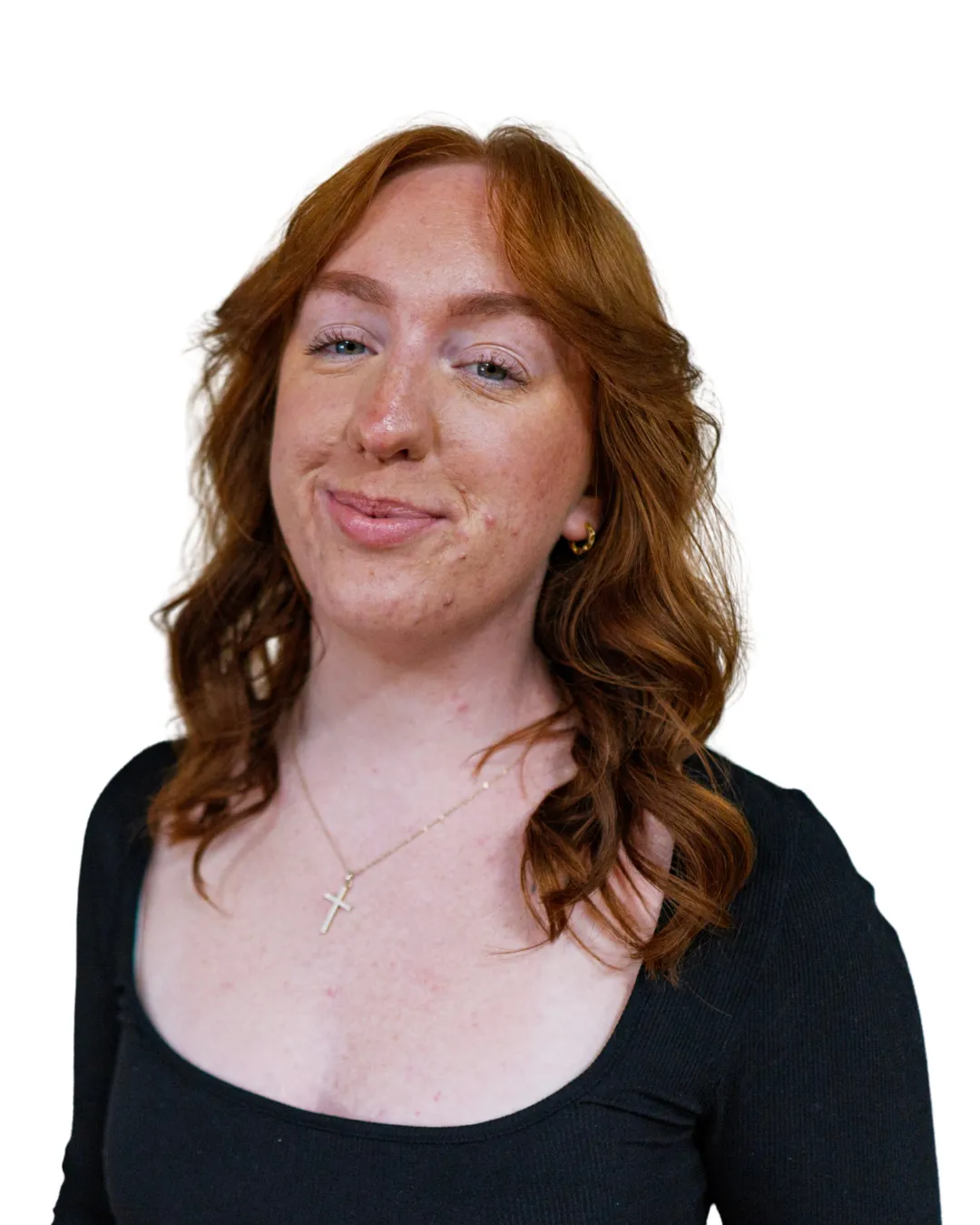 Female hairstylist with shoulder-length red hair and soft waves smiling in a professional headshot at Avera Hair Studio in Ocoee, Florida.