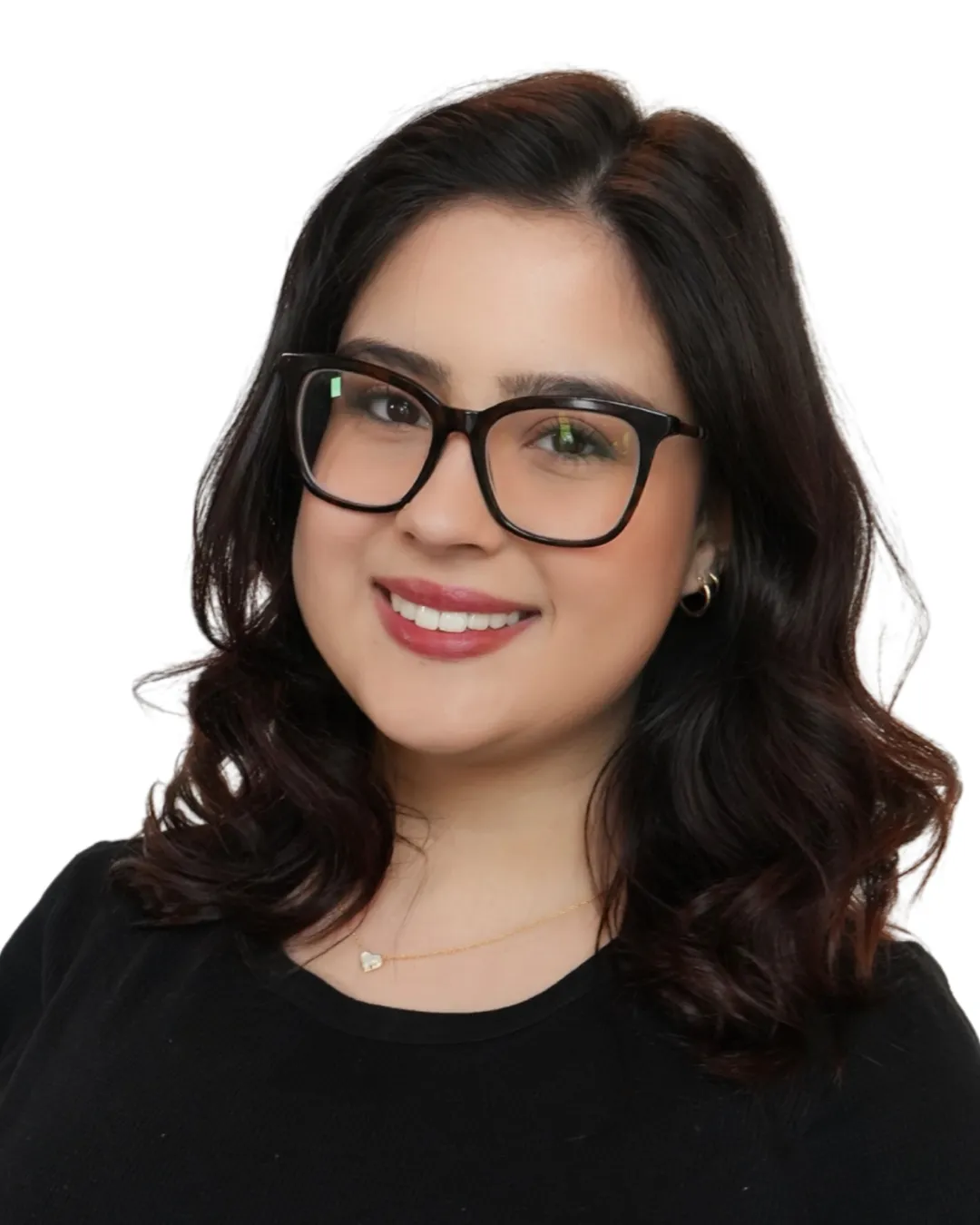 Professional hairstylist with shoulder-length dark wavy hair and glasses smiling against a clean white background at Avera Hair Studio in Ocoee, Florida.