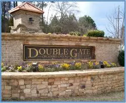 Roofer sealing ridge cap on gabled roof in Doublegate, Johns Creek GA