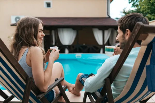 professional pool builder discussing custom pool design with homeowners in texas