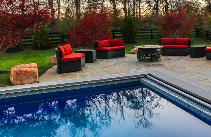 Outdoor living space with pool, pergola, and outdoor kitchen in an East Texas backyard
