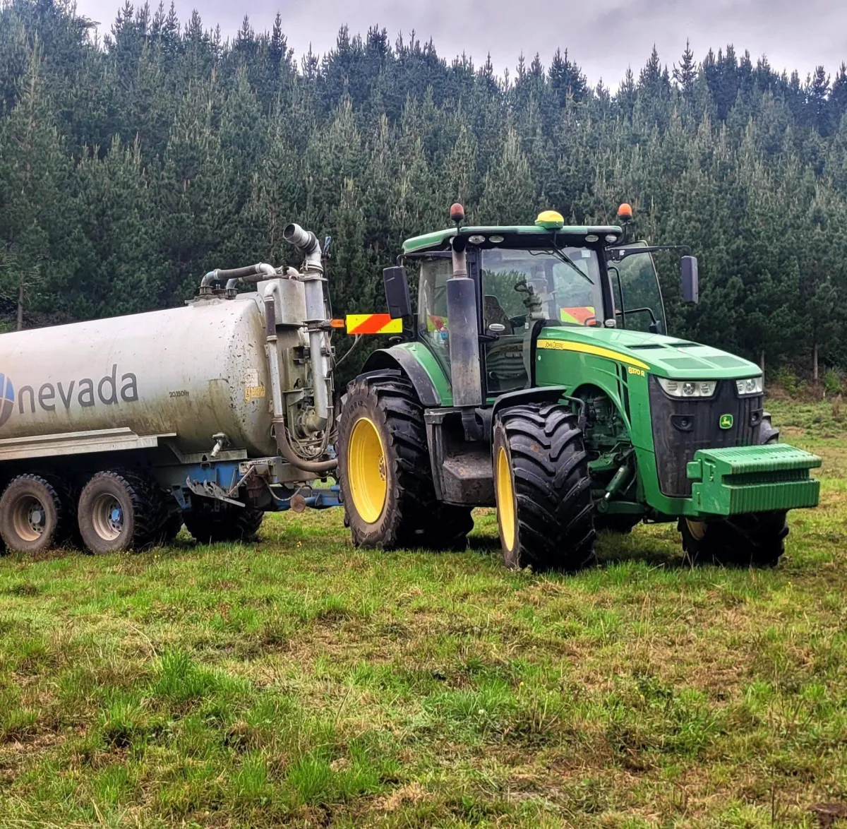 A&L Contracting NZ’s JD8530 tractor pumping effluent using Nevada technology in Taranaki