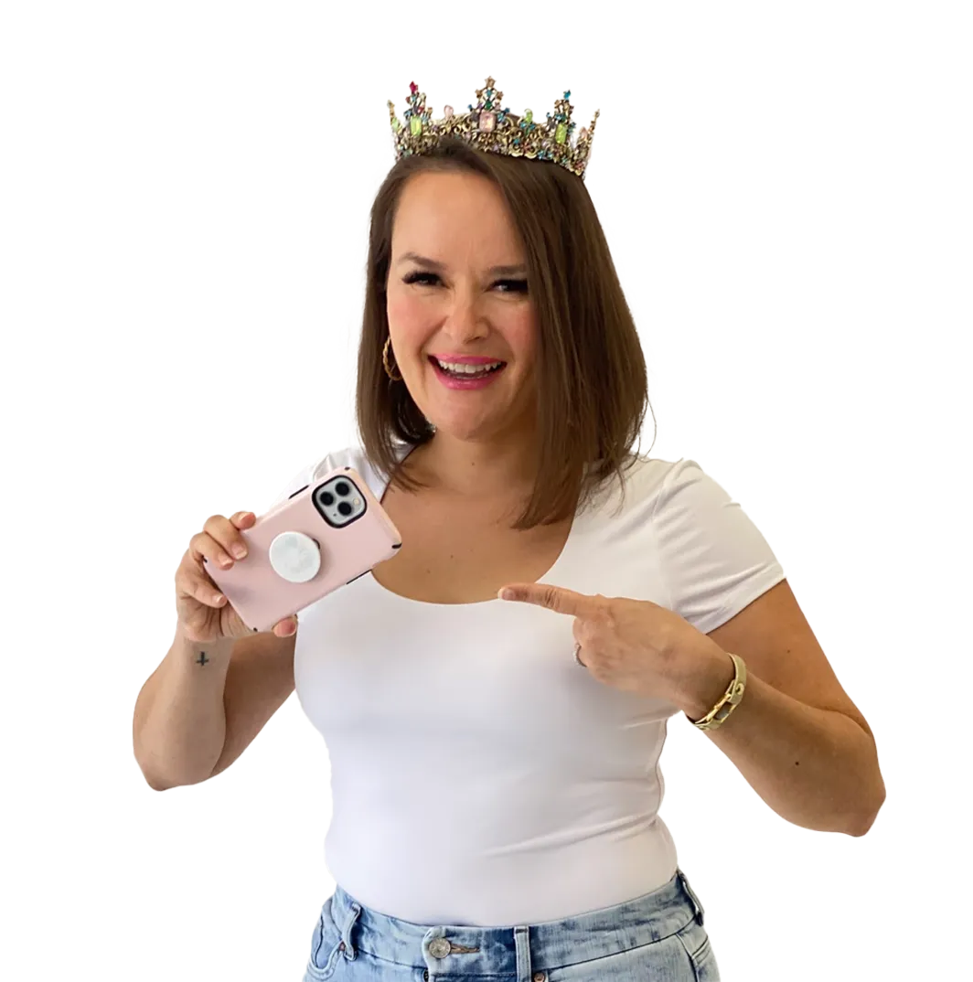 Photo of Andrea with crown on her head, pointing in her phone, while her other hand is holding the phone in a colorful paint splatter background