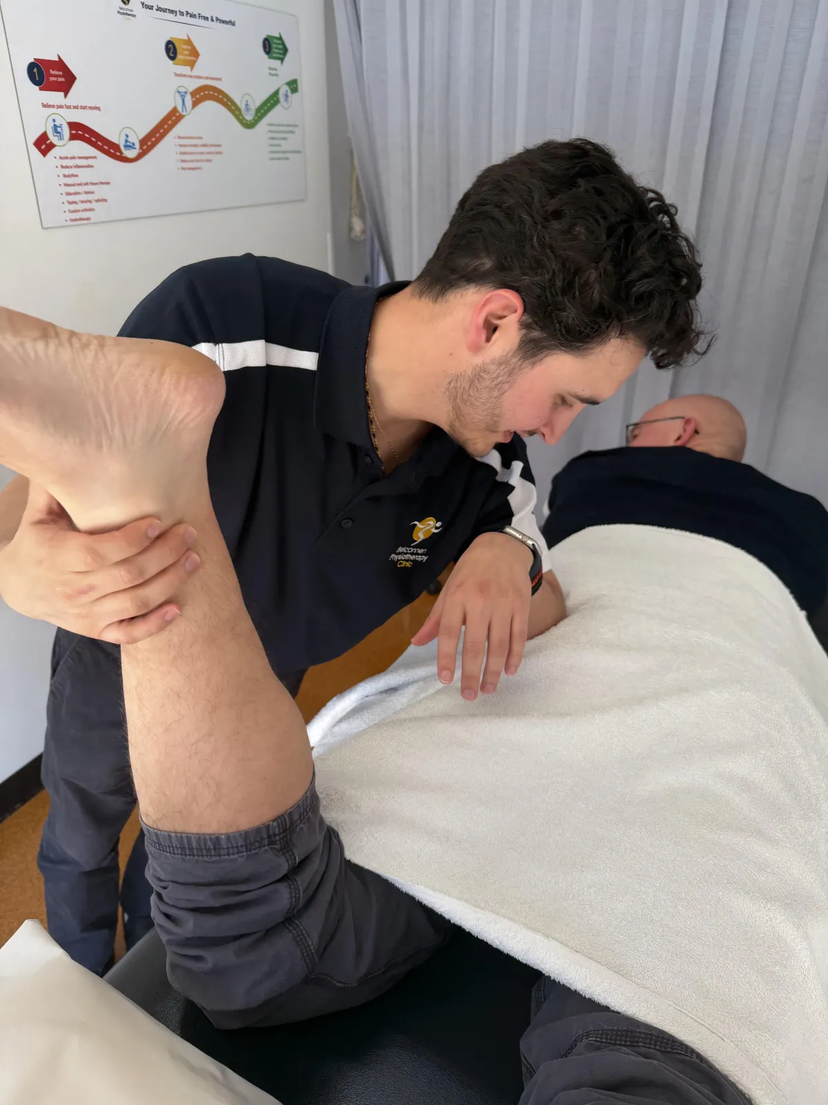 Physiotherapist assessing client in Belconnen physio clinic