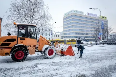 Commercial snow removal with loader and shoveling by Apple Valley Lawn & Snow.