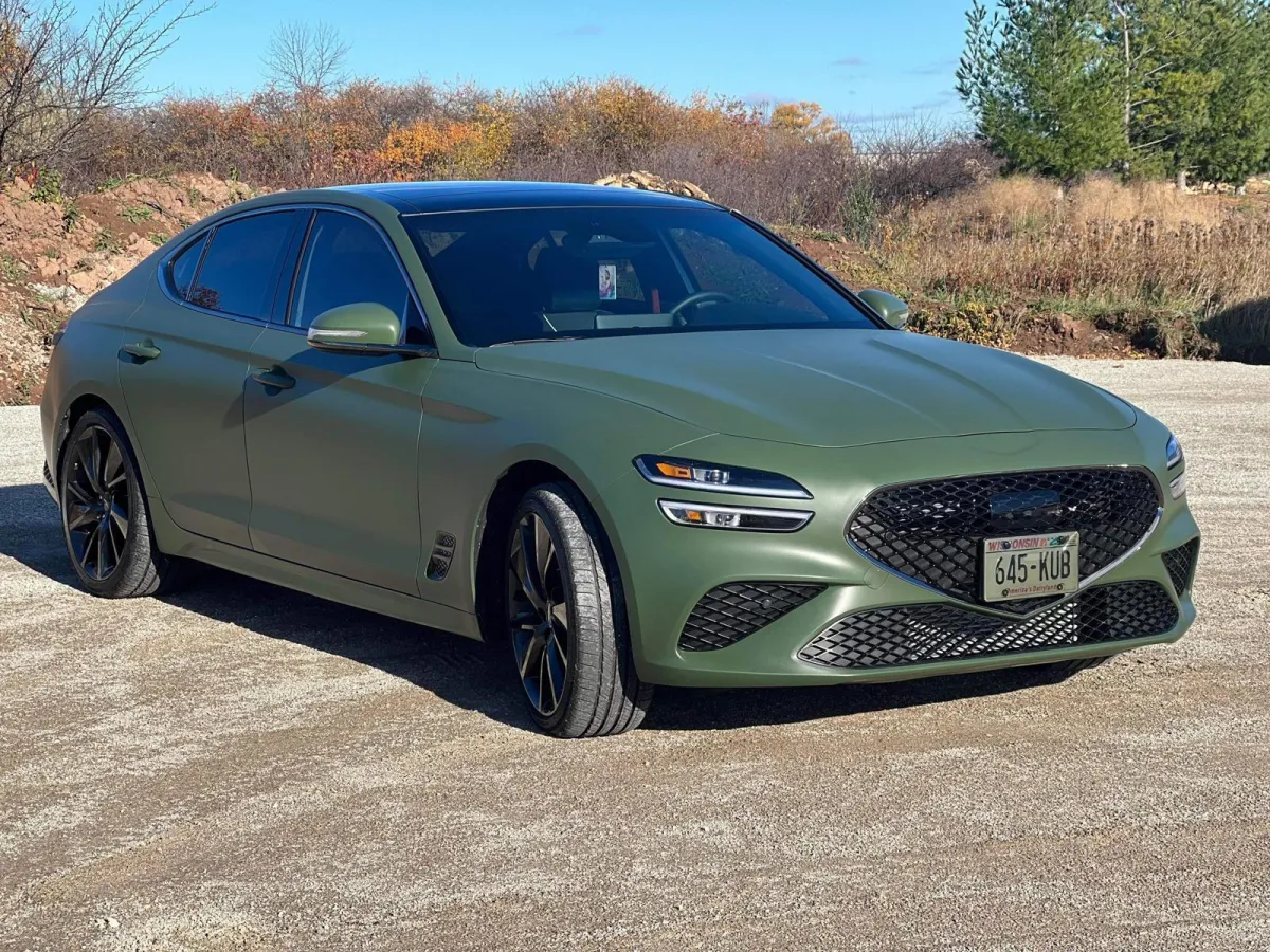 " Professional Car wrap Installation service on a Genesis G70 Green color by GB Enterprises AutoCare, located in Green Bay, WI . High-quality application on vehicle, demonstrating expert craftsmanship and attention to detail."