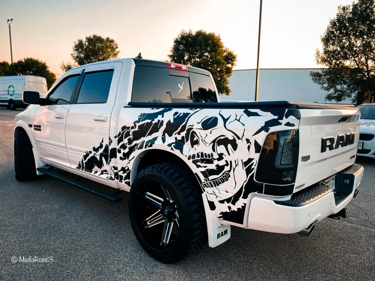 " Professional Car Wrap Installation service on a Dodge Ram White and  Black color by GB Enterprises AutoCare, located in Green Bay, WI . High-quality application on vehicle, demonstrating expert craftsmanship and attention to detail."