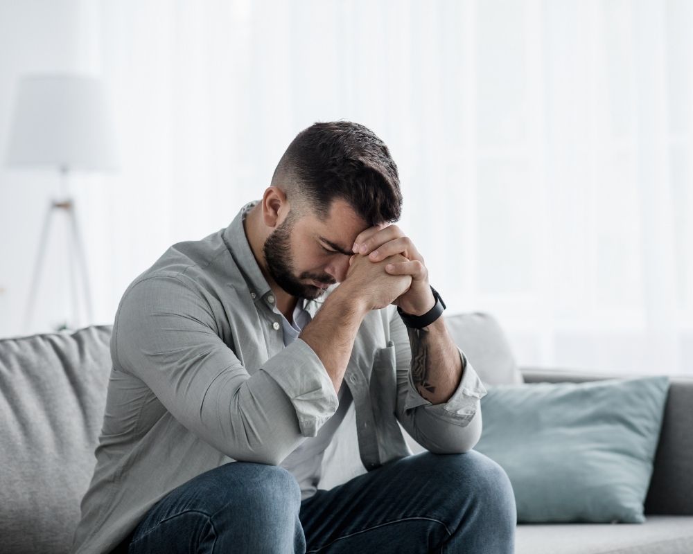 Man sitting with head in his hands fighting depression