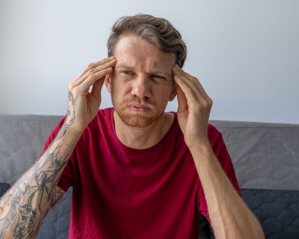 Man trying to focus on a task while struggling with ADHD