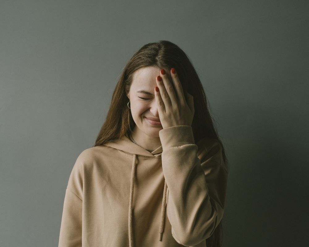 Woman covering half her face