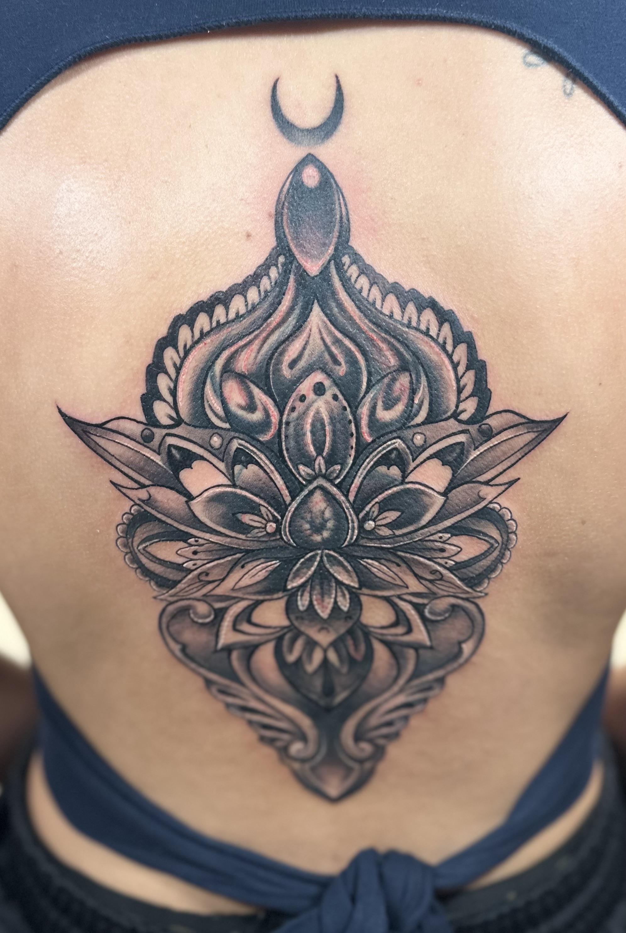 Abstract watercolor tattoo on a woman's shoulder, blending pastel pinks and blues with gold accents. The image is shot in a modern studio with a minimalist background. 1:1 aspect ratio.