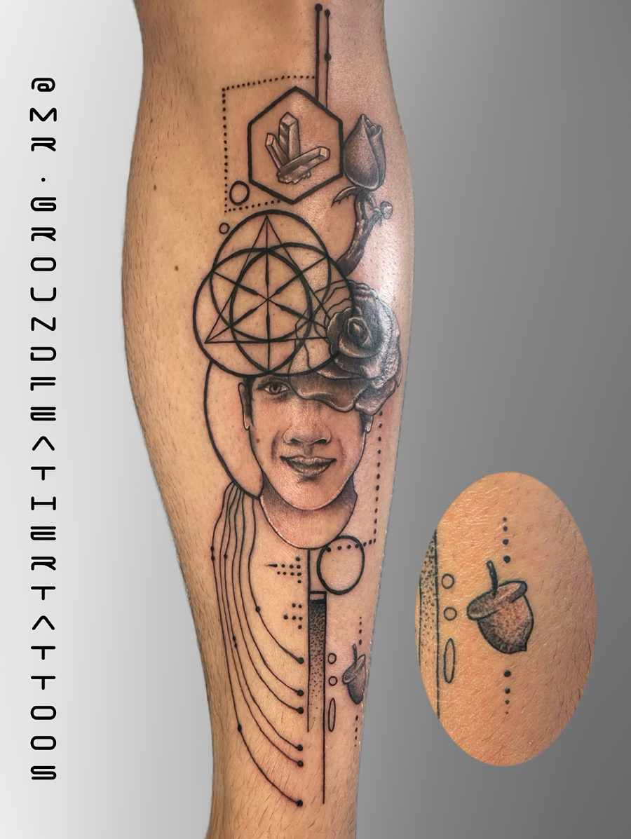 Minimalist linework tattoo of a botanical motif on a man's ankle, captured in a bright, airy space with a neutral backdrop. The style is clean and contemporary. 1:1 aspect ratio.