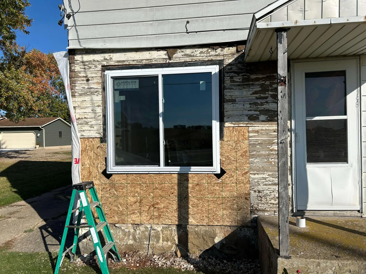 Custom kitchen remodel in West Michigan featuring white shaker cabinets, stainless appliances, and modern lighting by Archstone Homes.
