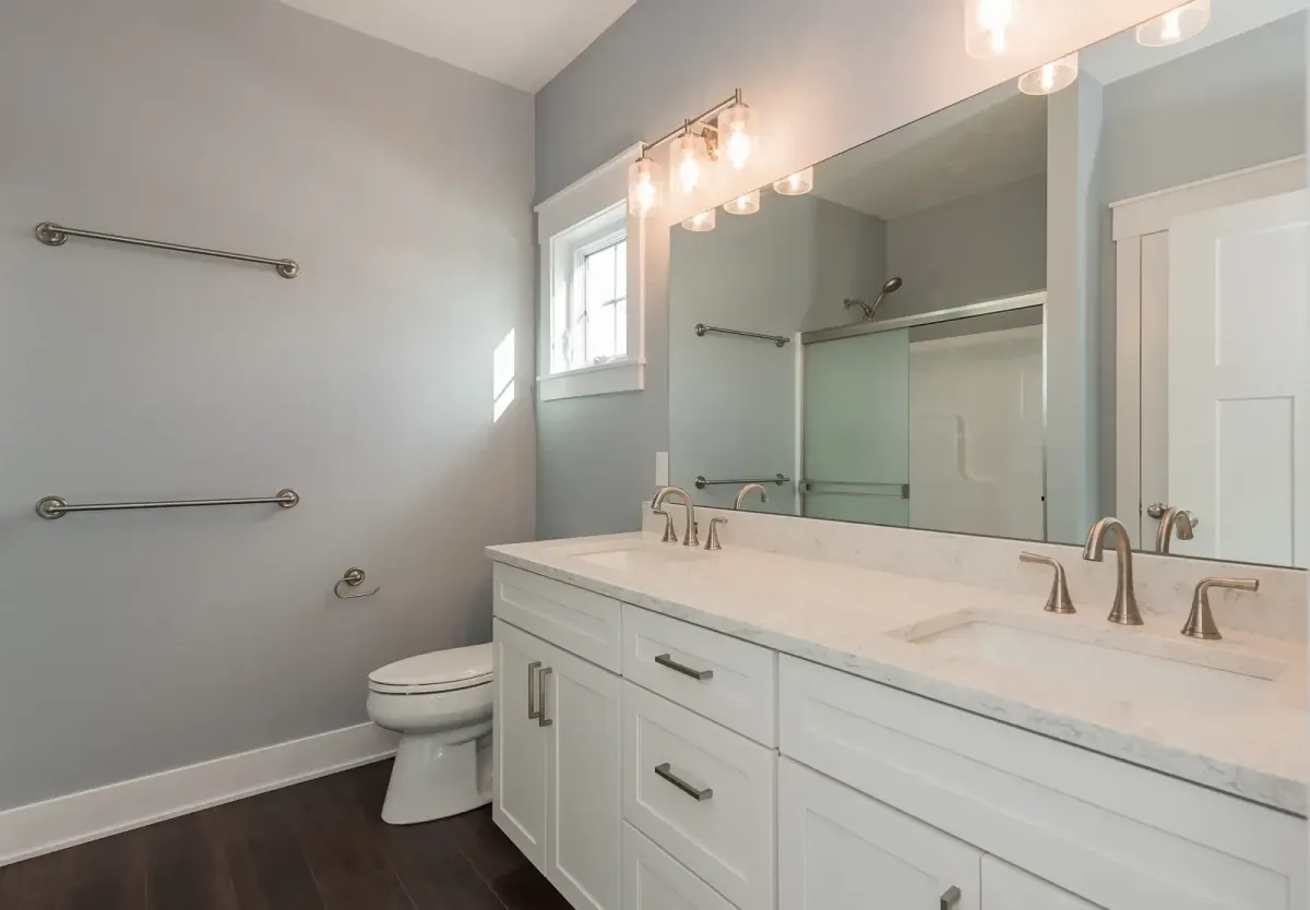 Custom bathroom remodel featuring bright vanity, new lighting, and waterproof finishes by Archstone Homes.