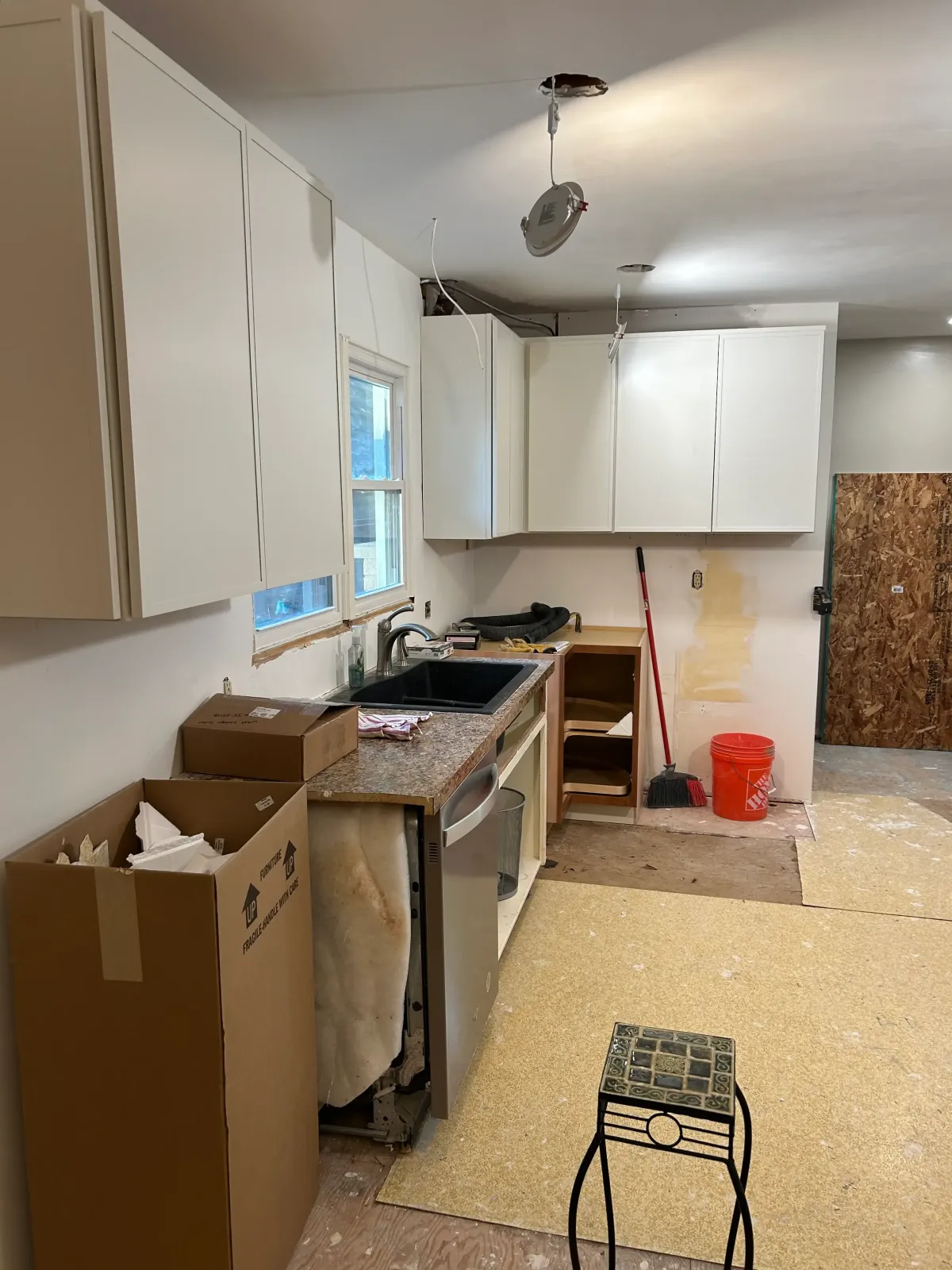 Before photo of a West Michigan kitchen remodel showing cabinet removal and early construction by Archstone Homes.