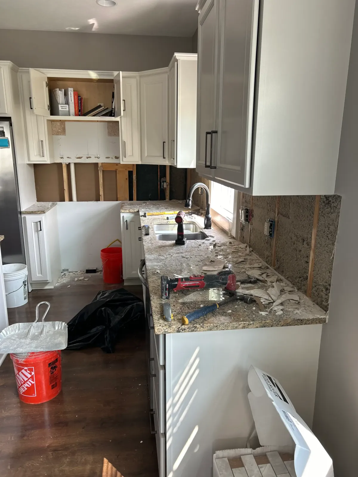 Kitchen remodel mid-project showing countertop installation and cabinet upgrades.