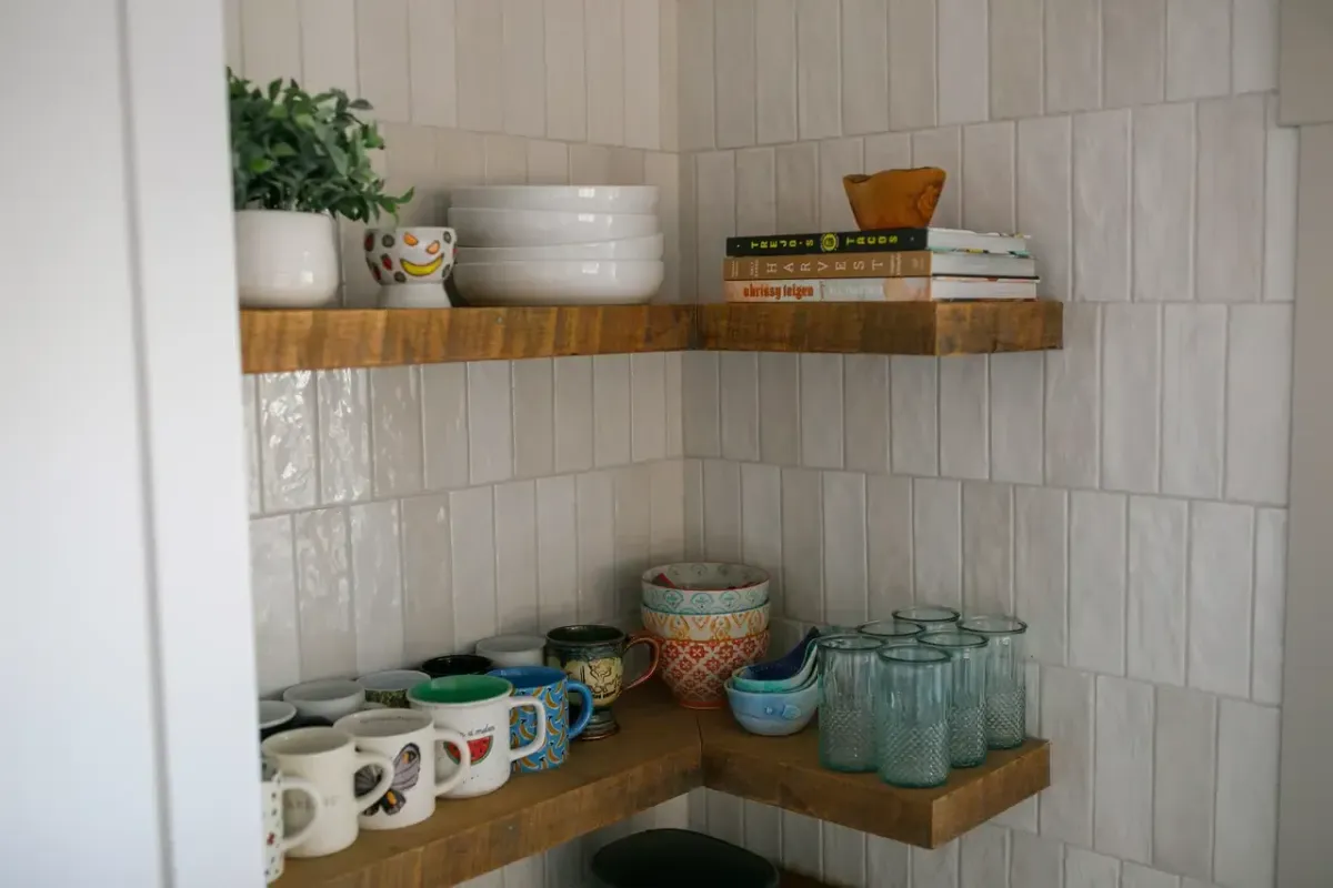 Custom kitchen remodel in West Michigan featuring white shaker cabinets, stainless appliances, and modern lighting by Archstone Homes.