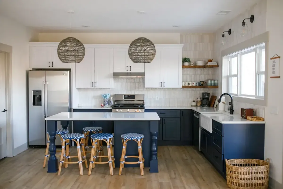 Custom kitchen remodel in West Michigan featuring white shaker cabinets, stainless appliances, and modern lighting by Archstone Homes.