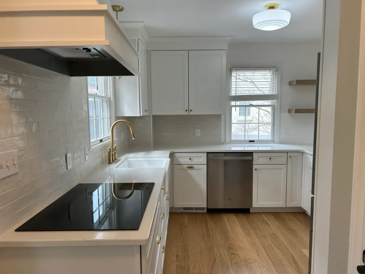 Custom kitchen remodel in West Michigan featuring white shaker cabinets, stainless appliances, and modern lighting by Archstone Homes.