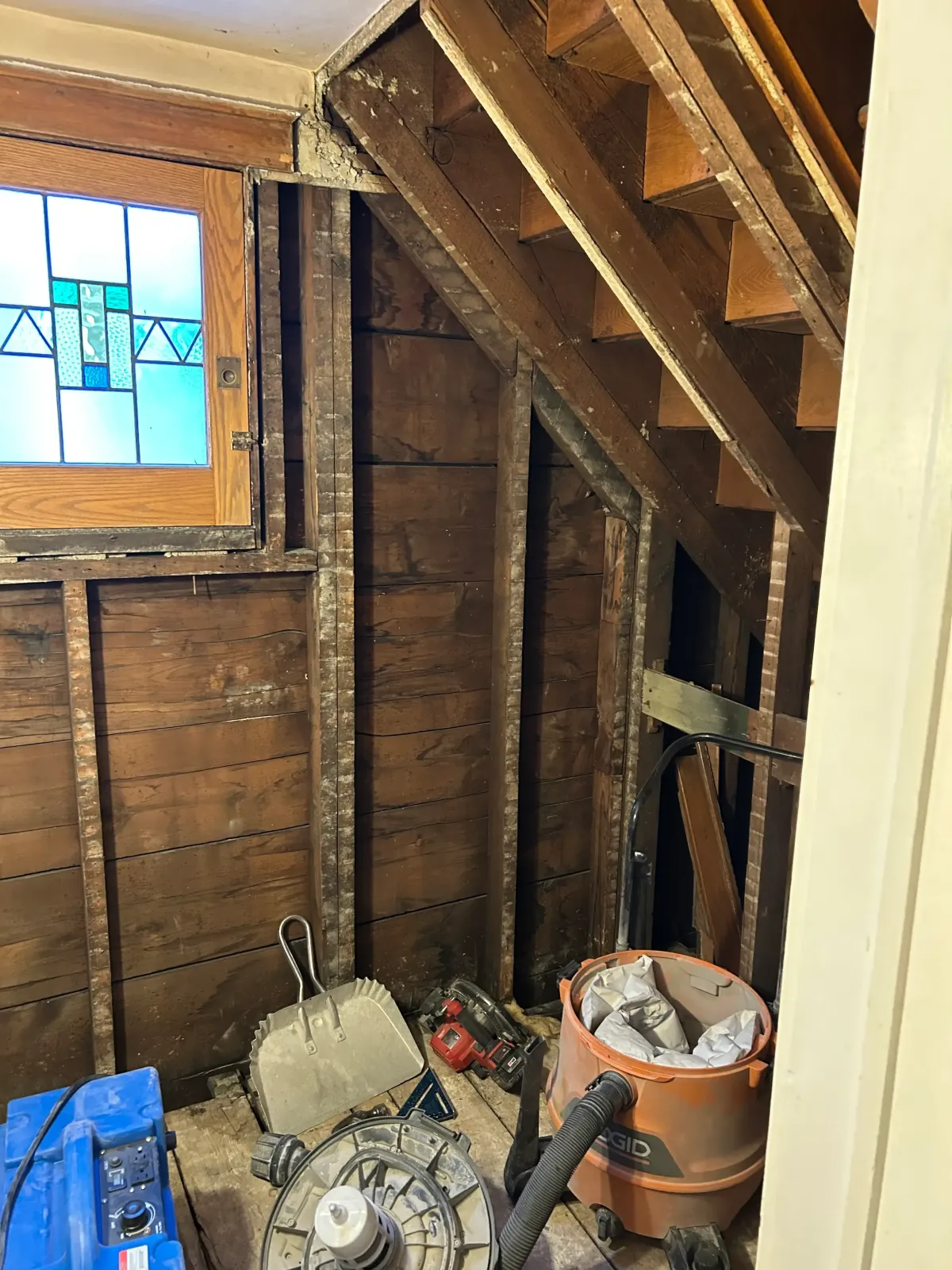 Bathroom remodel stripped to the studs showing structural framing and preparation for a high-performance waterproof locker room style shower system.