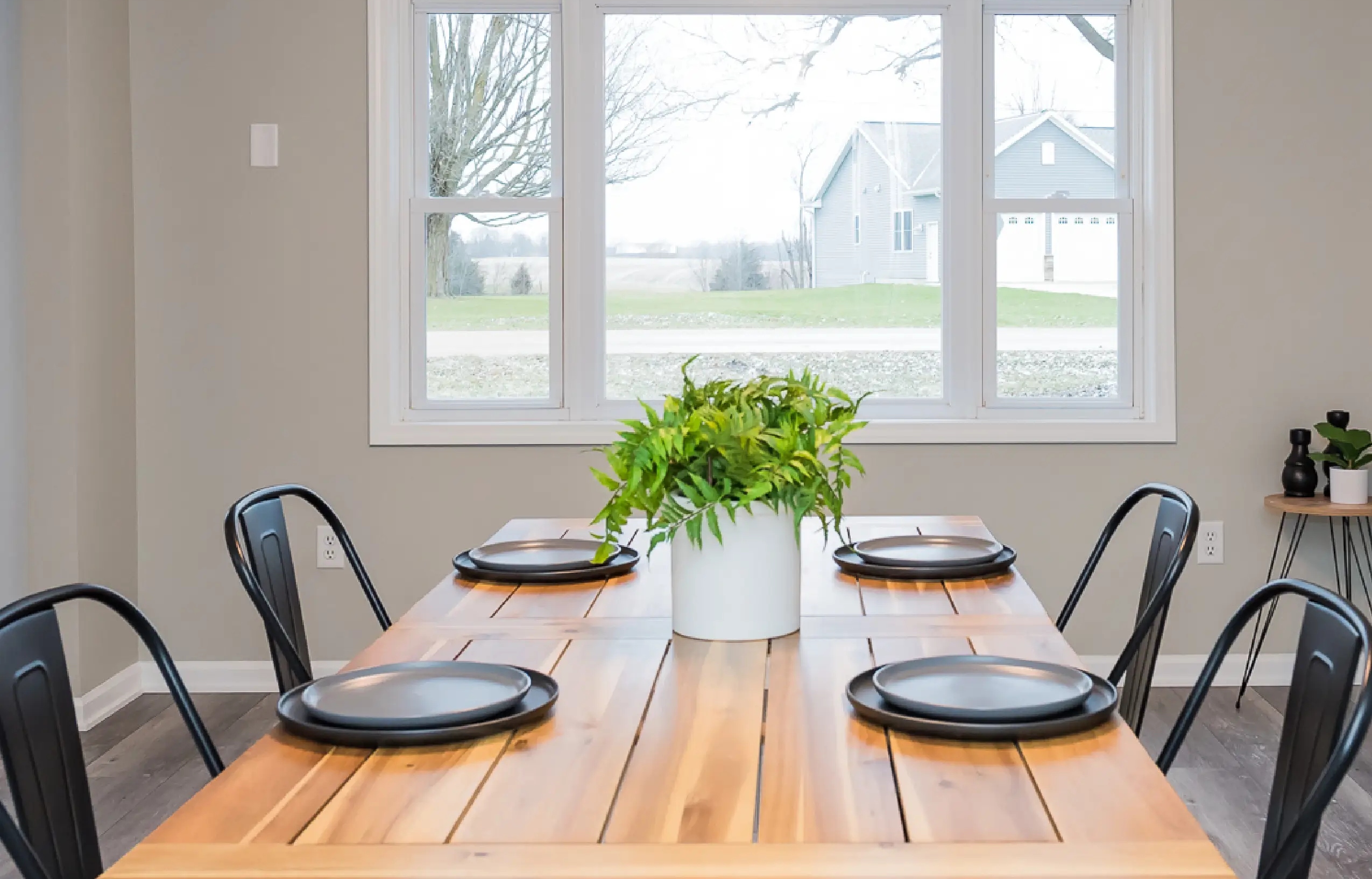 Custom kitchen remodel in West Michigan featuring white shaker cabinets, stainless appliances, and modern lighting by Archstone Homes.