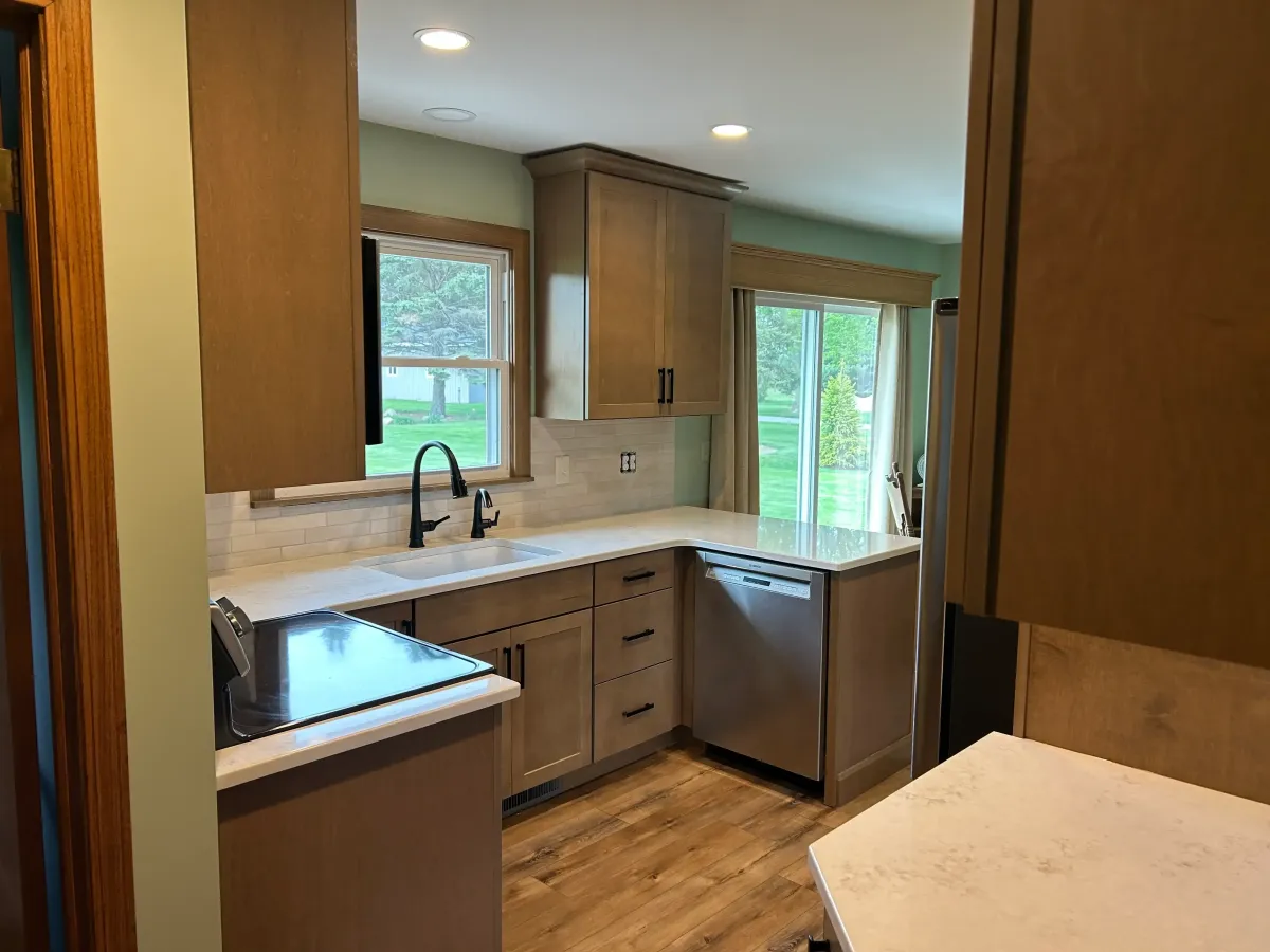 Remodeled kitchen with dark countertops and updated cabinetry in a Grand Rapids, MI home