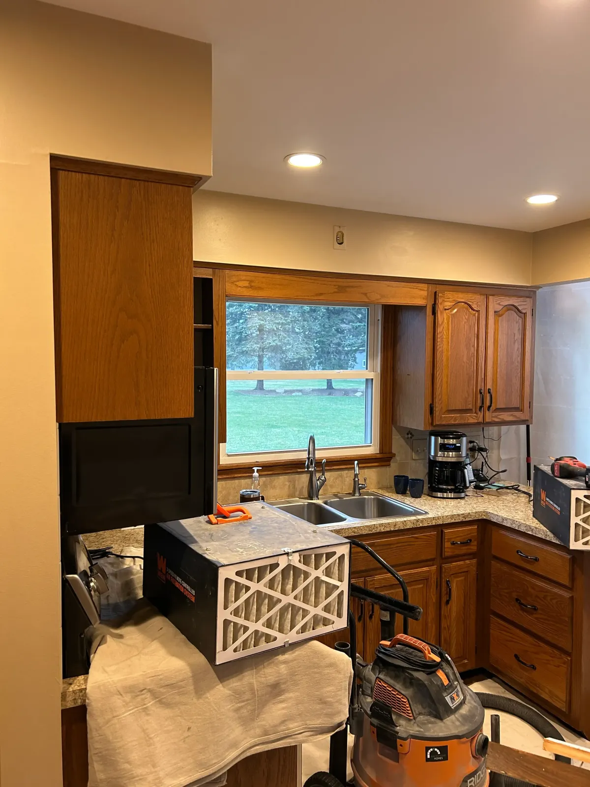 Kitchen remodel in progress with cabinetry protected during renovation in Grand Rapids, MI