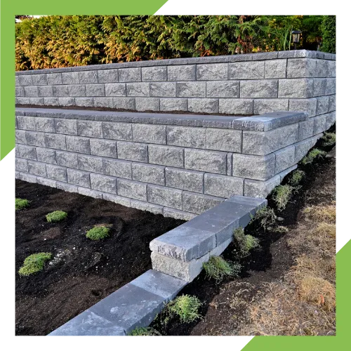 Landscape retaining wall construction for a sloped home yard