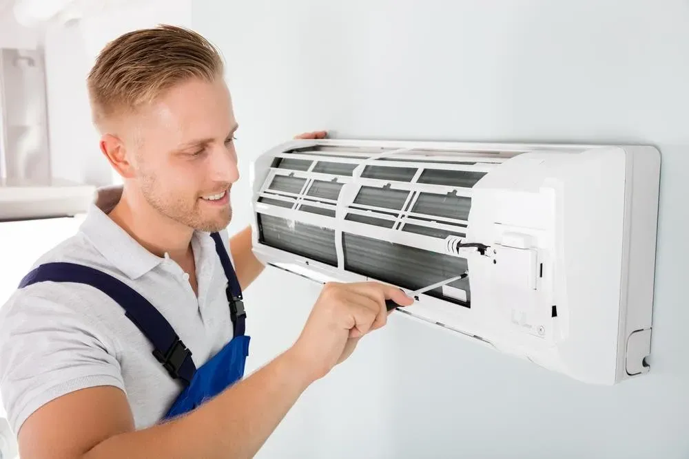 Air conditioner repair technician at work