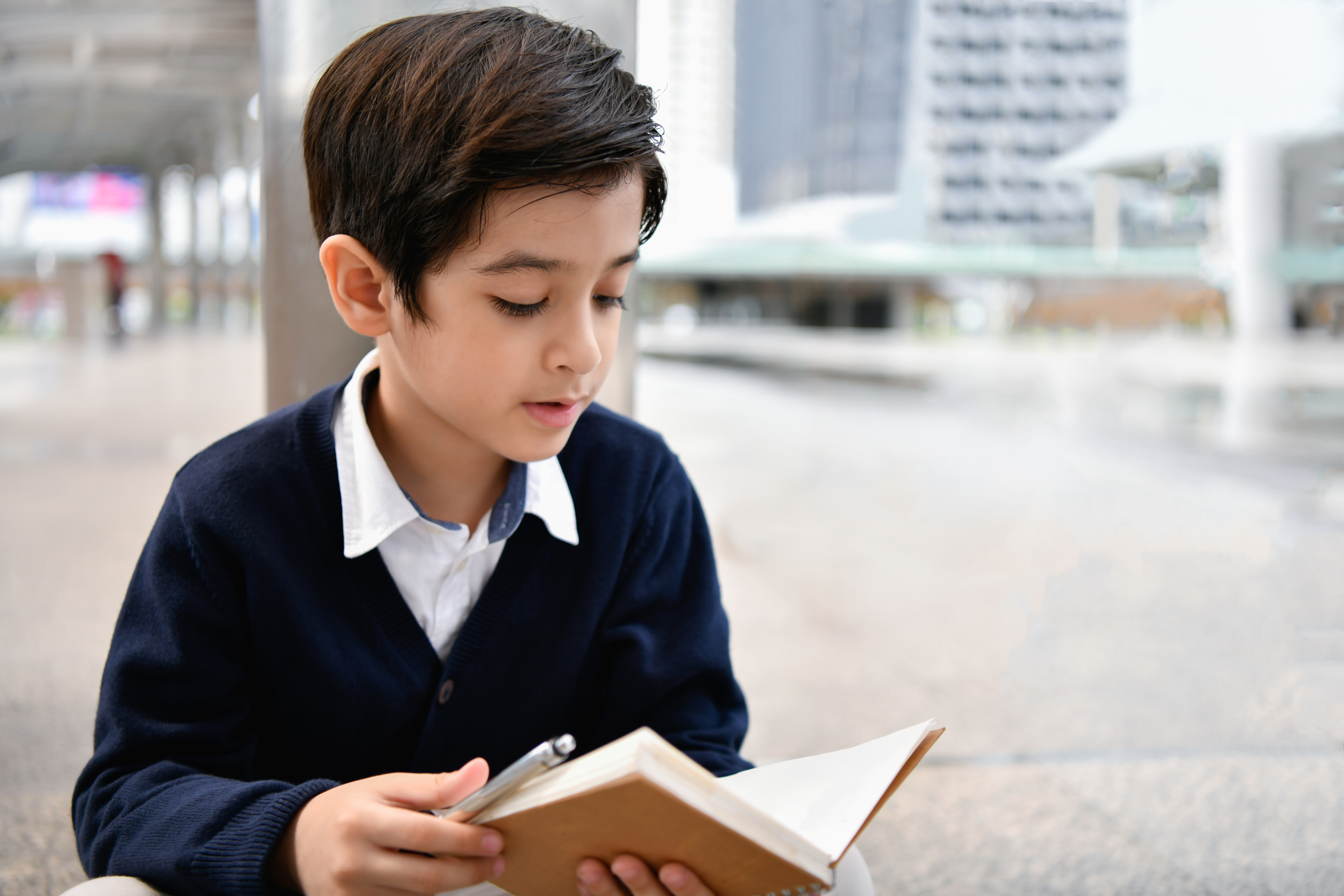 Speaker addressing a large audience in a dimly lit hall