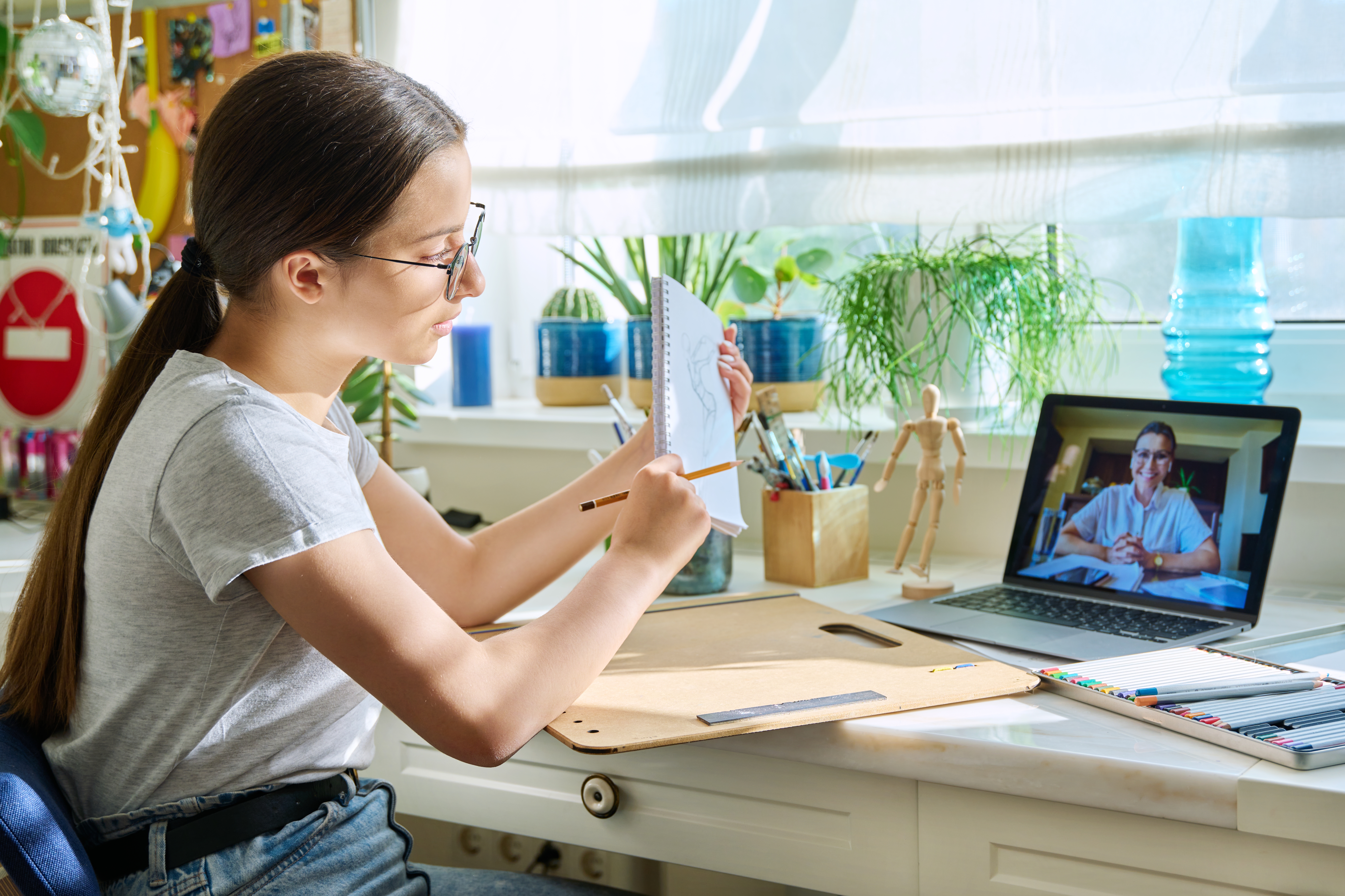 Elderly scientist teaches young boy in lab coat.