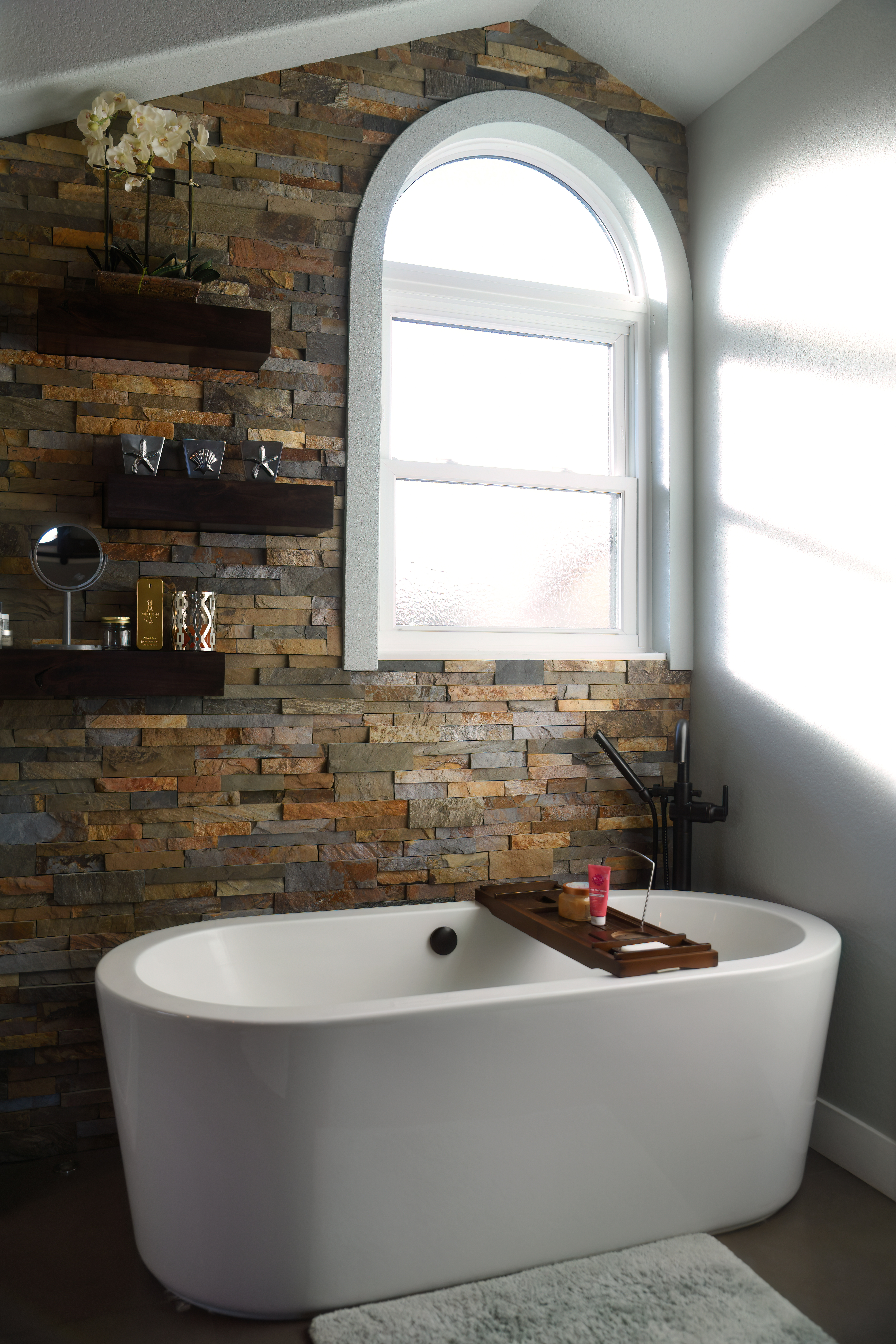 A modern living room with large, custom high-efficiency windows and a sleek glass door, sunlight streaming in, lush greenery visible outside, contemporary furniture, and a cozy, inviting atmosphere.