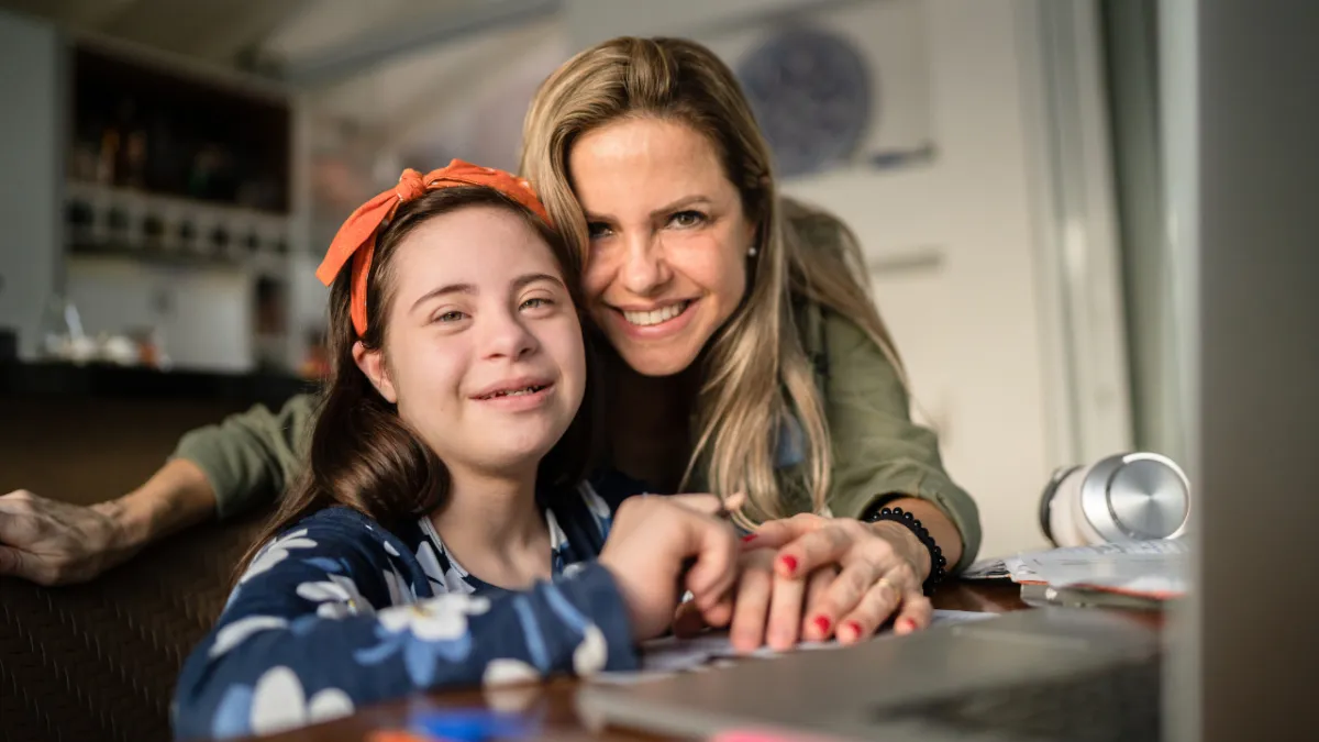 Mother and daughter smiling together at home, representing long-term planning and support for a loved one with a disability