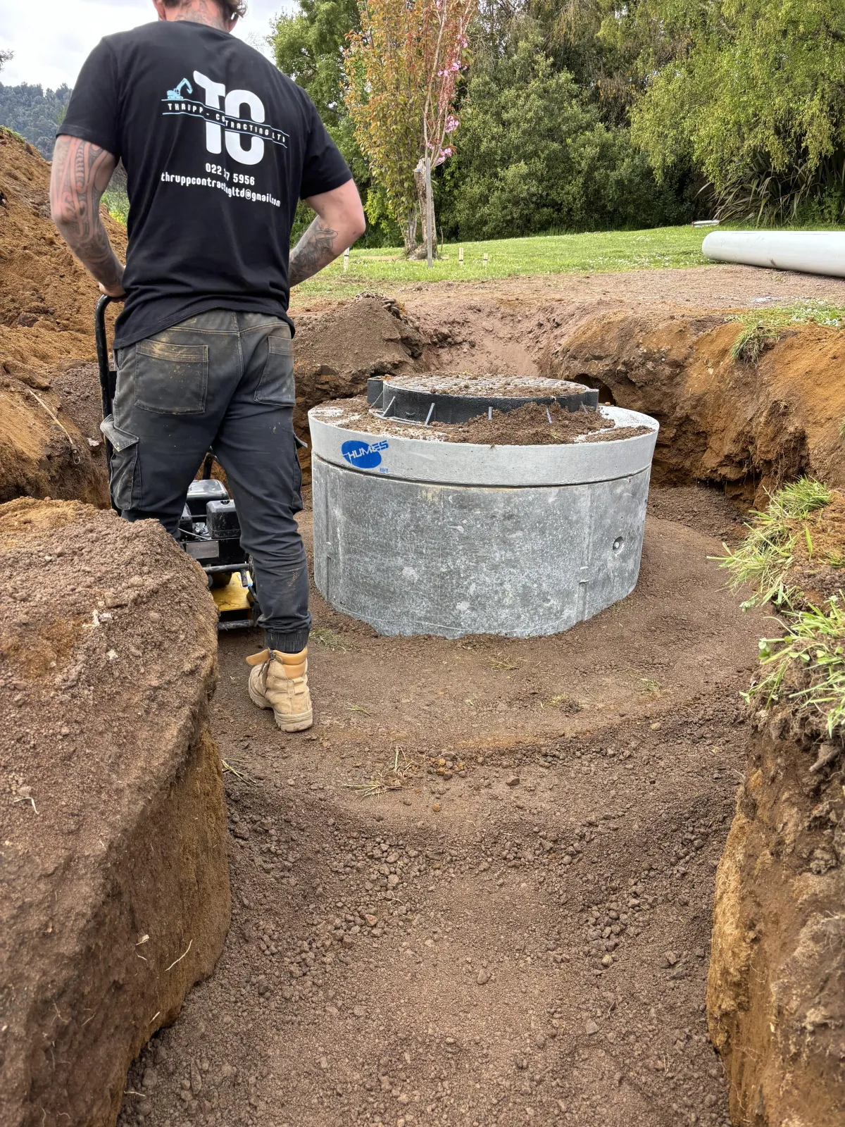 Drain laying work in progress, installing drainage systems for a residential property.