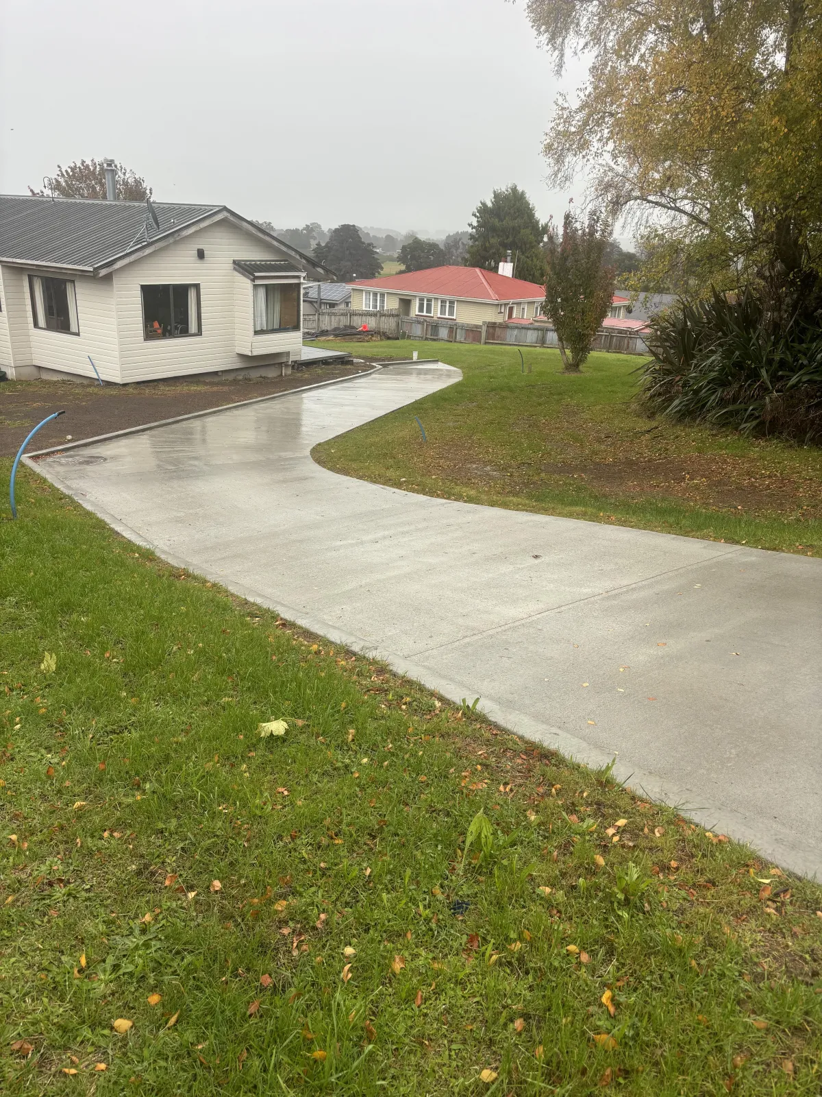 Subdivision development with concrete driveway and residential buildings in Ohakune.