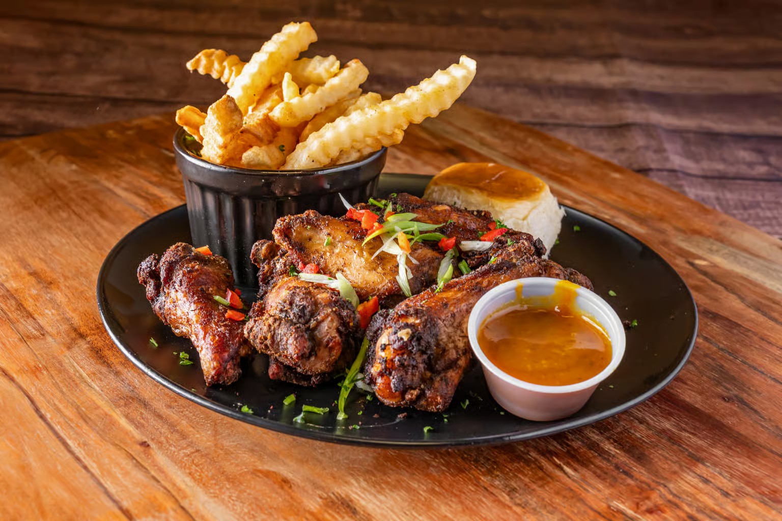 Macro shot of steaming jerk chicken with visible texture and deep shadow