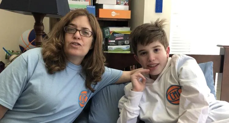 parent and child smiling after hearing their Happy Heart Song for the first time