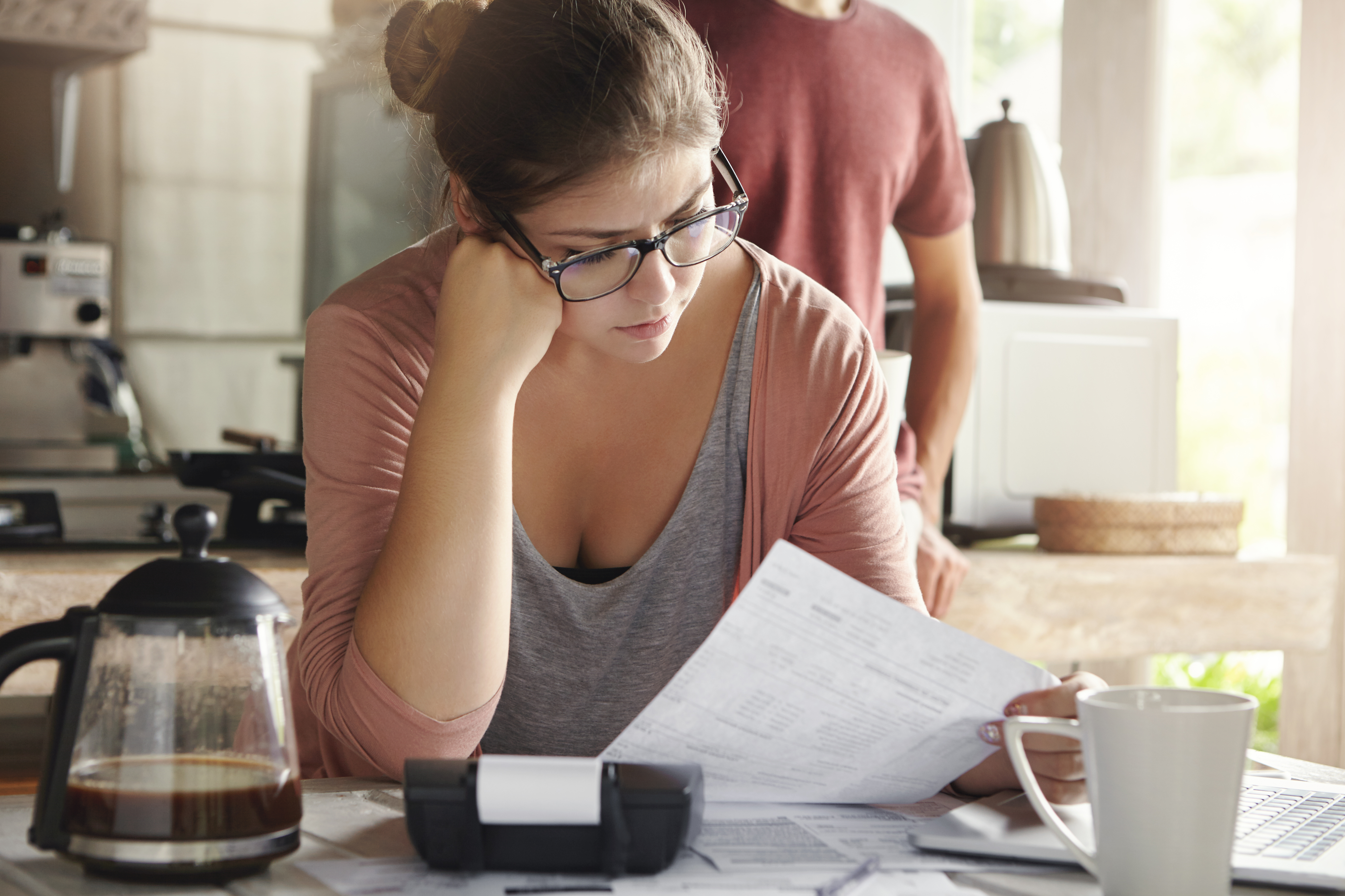 Homeowner reviewing property documents while learning about deed fraud and real estate title scams.