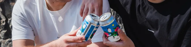 A photo of two guys having a toast with Fernet Hunter Peach Tea