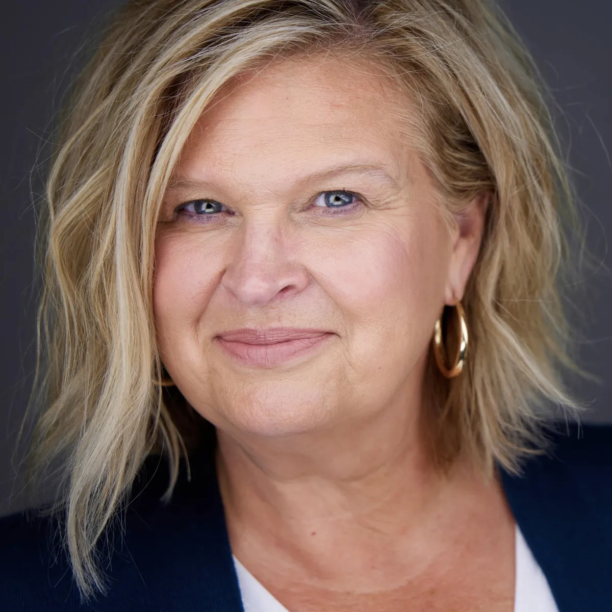 Elegant portrait of a woman in her 50s in soft studio light