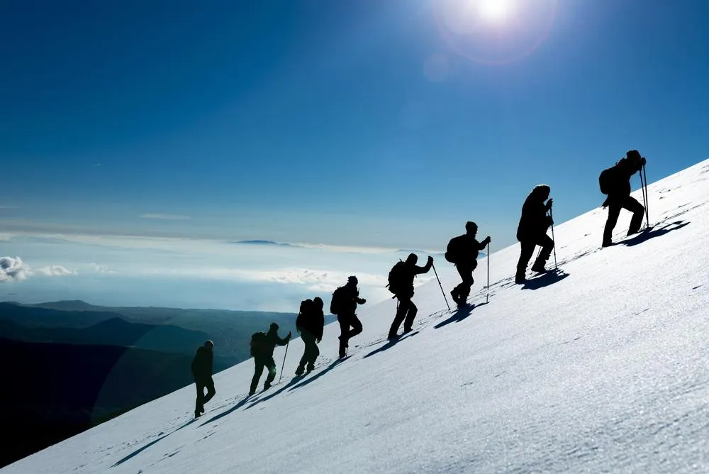 A group of men climbing a mountain. Resilience and Leadership