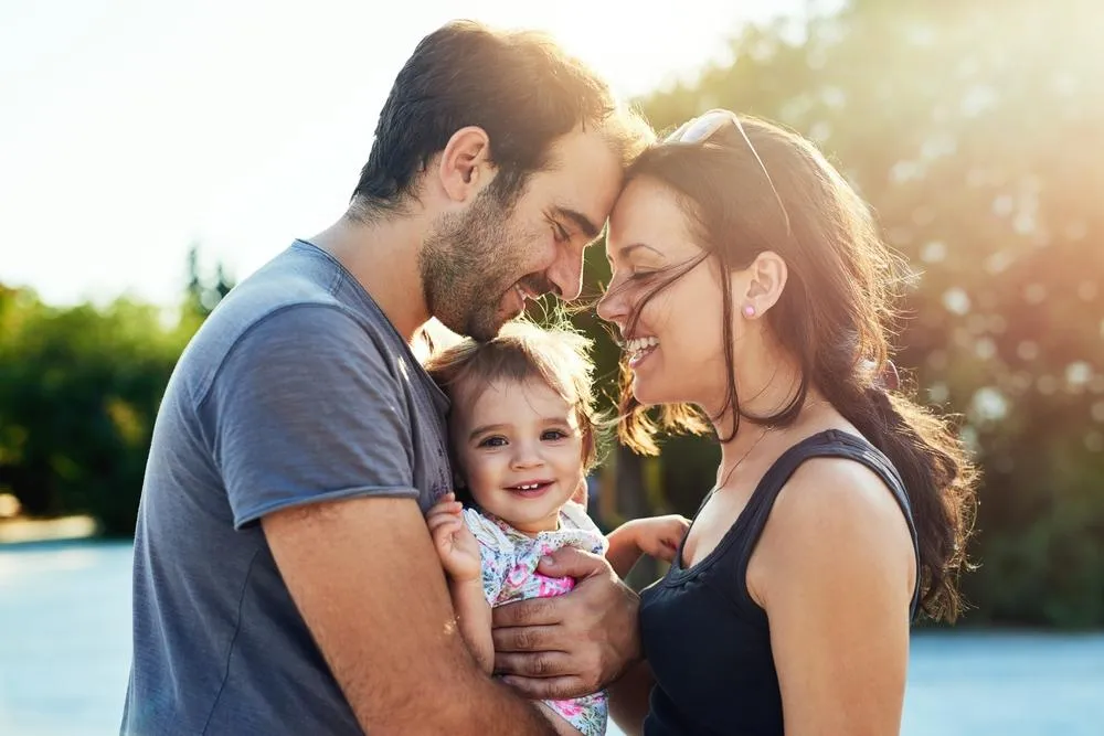 A couple holding a baby. Relationship and Connections