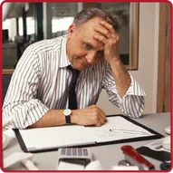Business professional showing frustration while reviewing documents and using a calculator