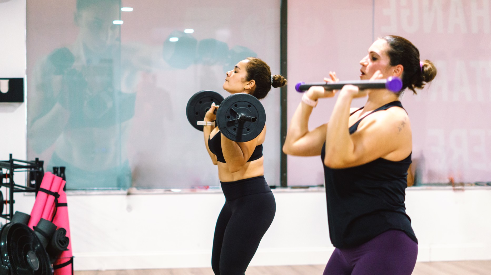 A woman strength training with her coach at Winter Club, a women-only studio in Fort Myers.