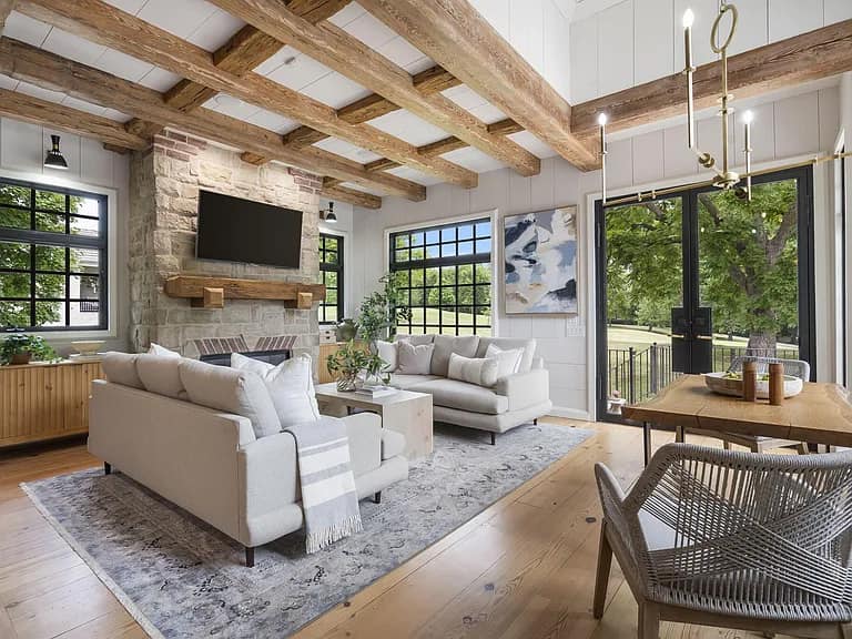 Staged living room with exposed wood beams and cozy seating arrangement