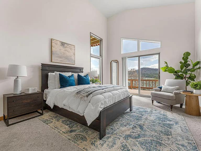 Bright staged bedroom with layered bedding and natural light
